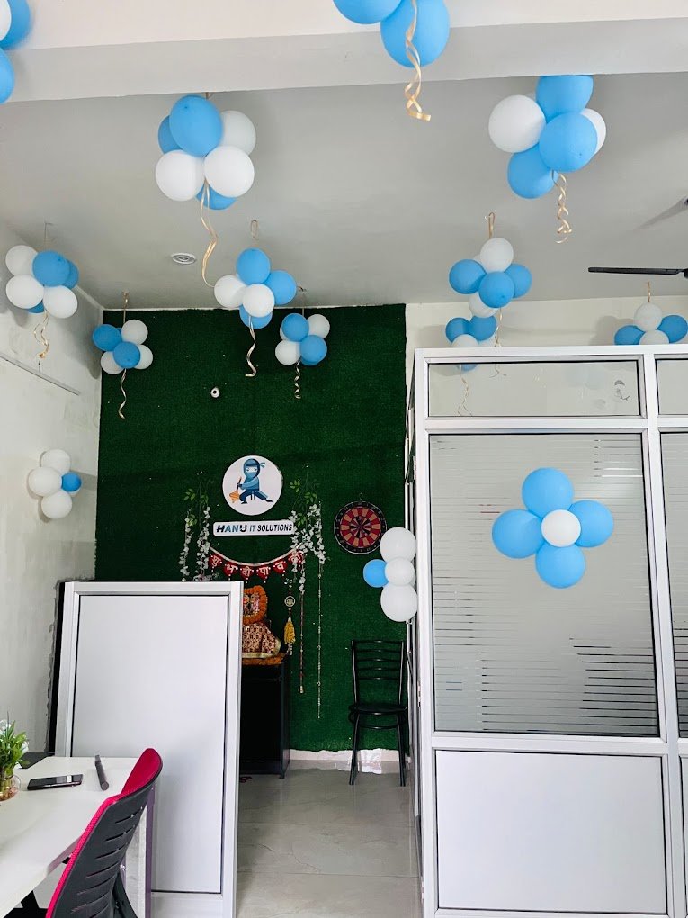 Office cabin decorated with balloons, featuring lakshmi idol and company branding-HanuiT solutions
